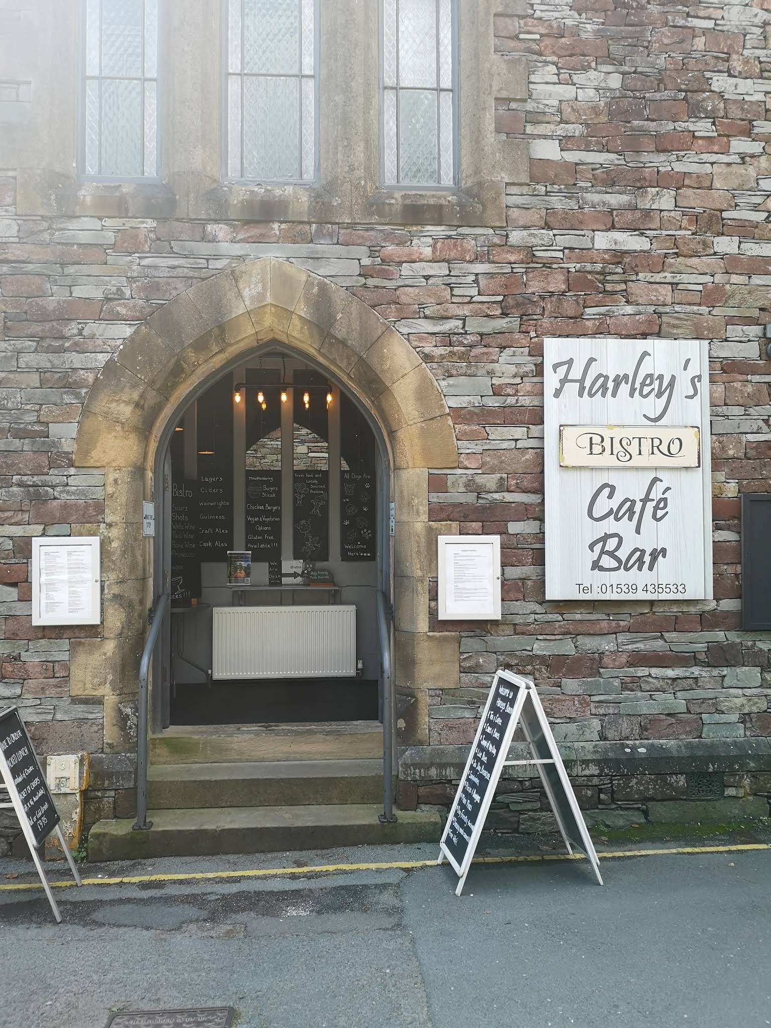Harley’s complete stone arched entrance with its Bistro Café Bar sign and front steps